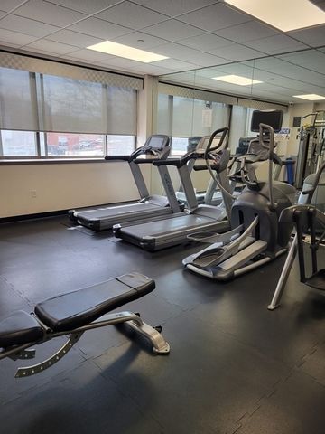 a room with gym equipment and window