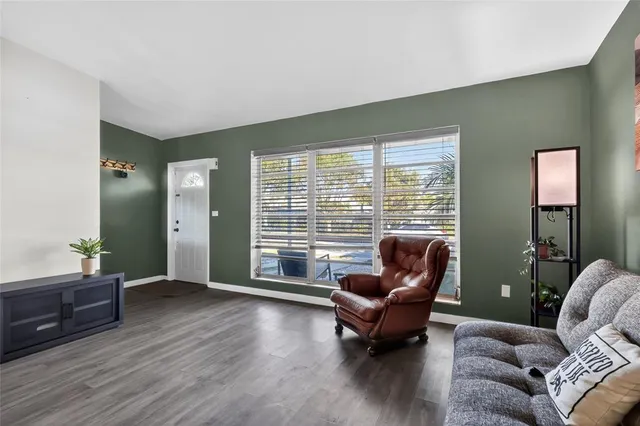 a living room with furniture and a large window