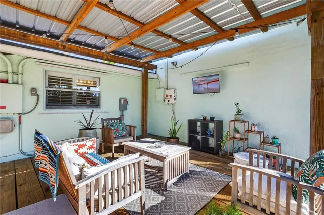 a view of a porch with a table and chairs under an umbrella