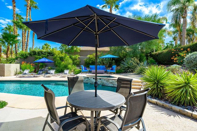 a patio with a patio table and chairs