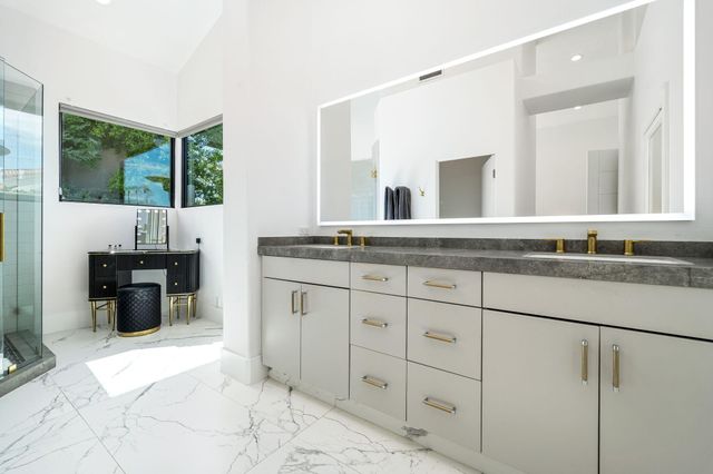 a bathroom with a granite countertop sink mirror and double