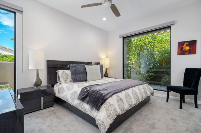 a bedroom with a large bed and a window