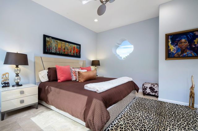 a bedroom with a bed and a painting on the wall