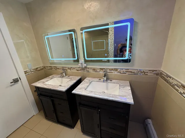 a bathroom with a sink vanity and a mirror
