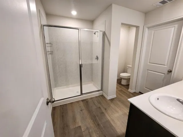 a bathroom with a shower and a toilet