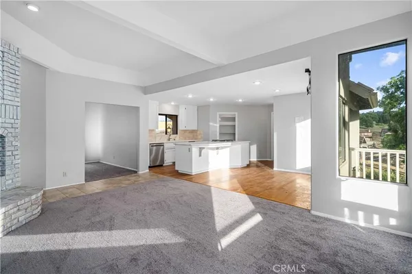 a view of a kitchen with a sink and a living room