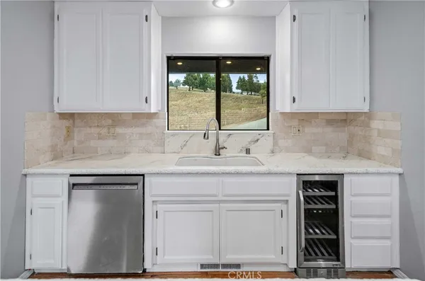a kitchen with a sink and cabinets