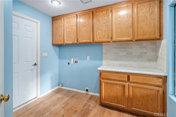 a room with wooden cabinets and a window