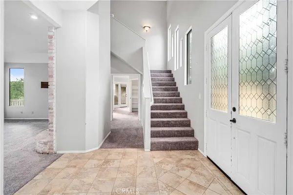 a view of a hallway with wooden floor and entryway