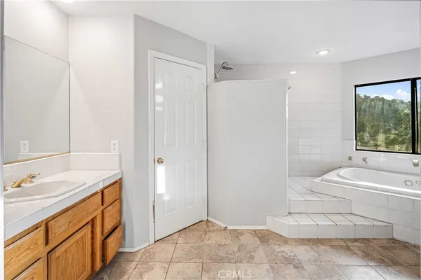 a bathroom with a bathtub and window