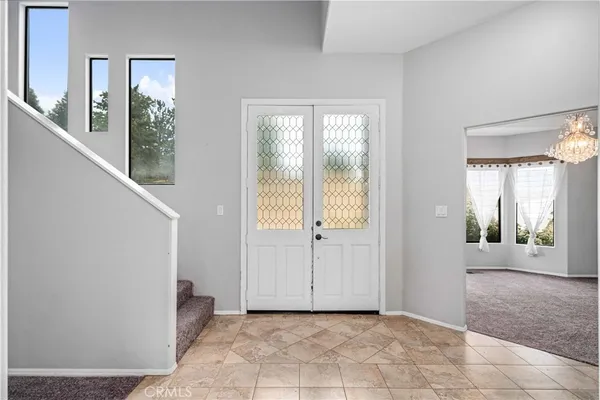 a view of a hallway with windows and entryway