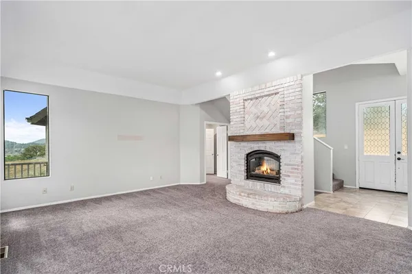 an empty room with furniture and fireplace