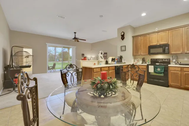 a view of a dining room with furniture and a chandelier