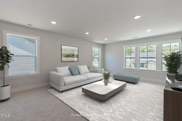 a living room with furniture and a floor to ceiling window