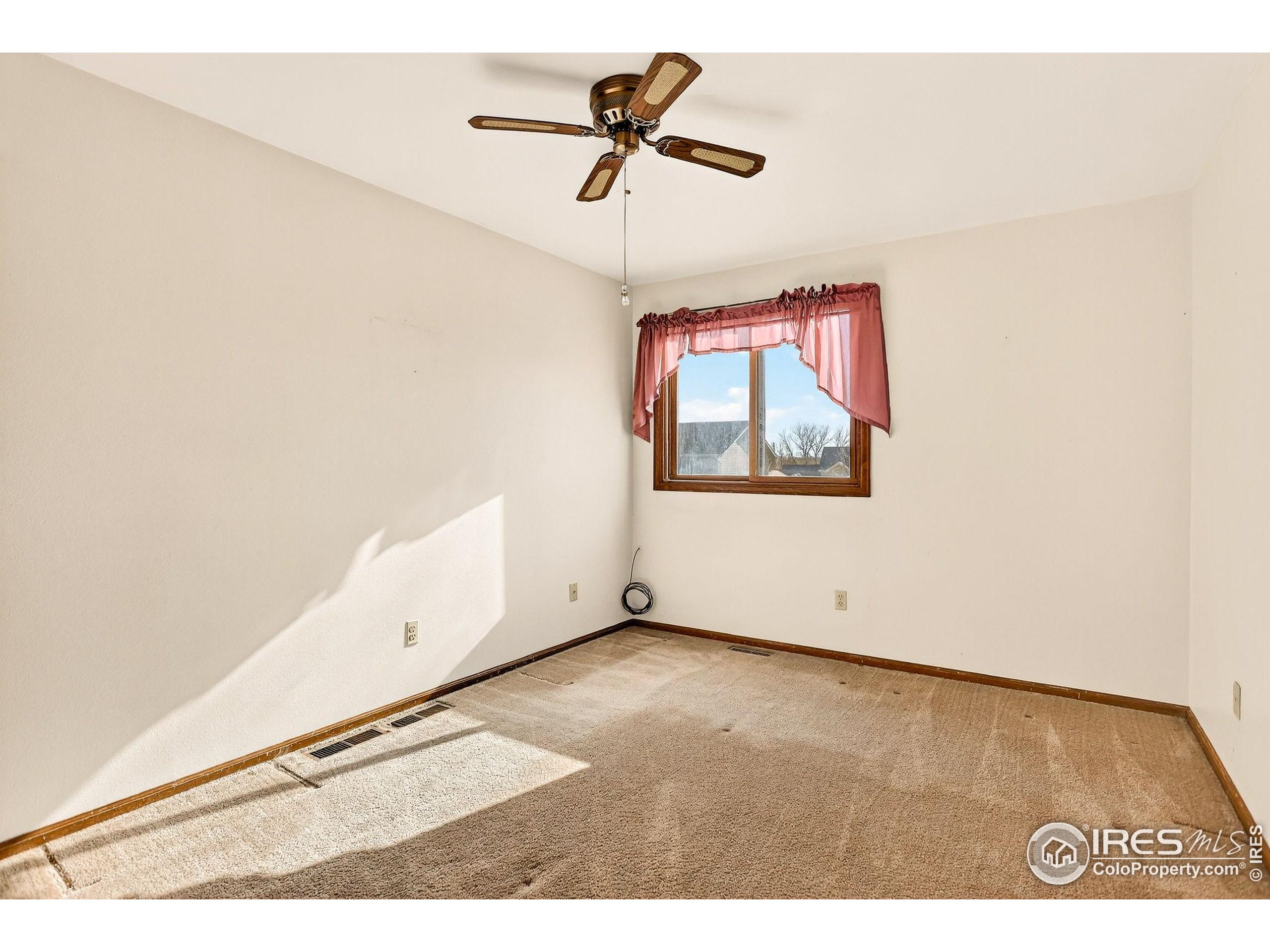 809 Jay Place Berthoud, CO 80513 - Photo 16 of 31 an empty room with a window and a ceiling fan