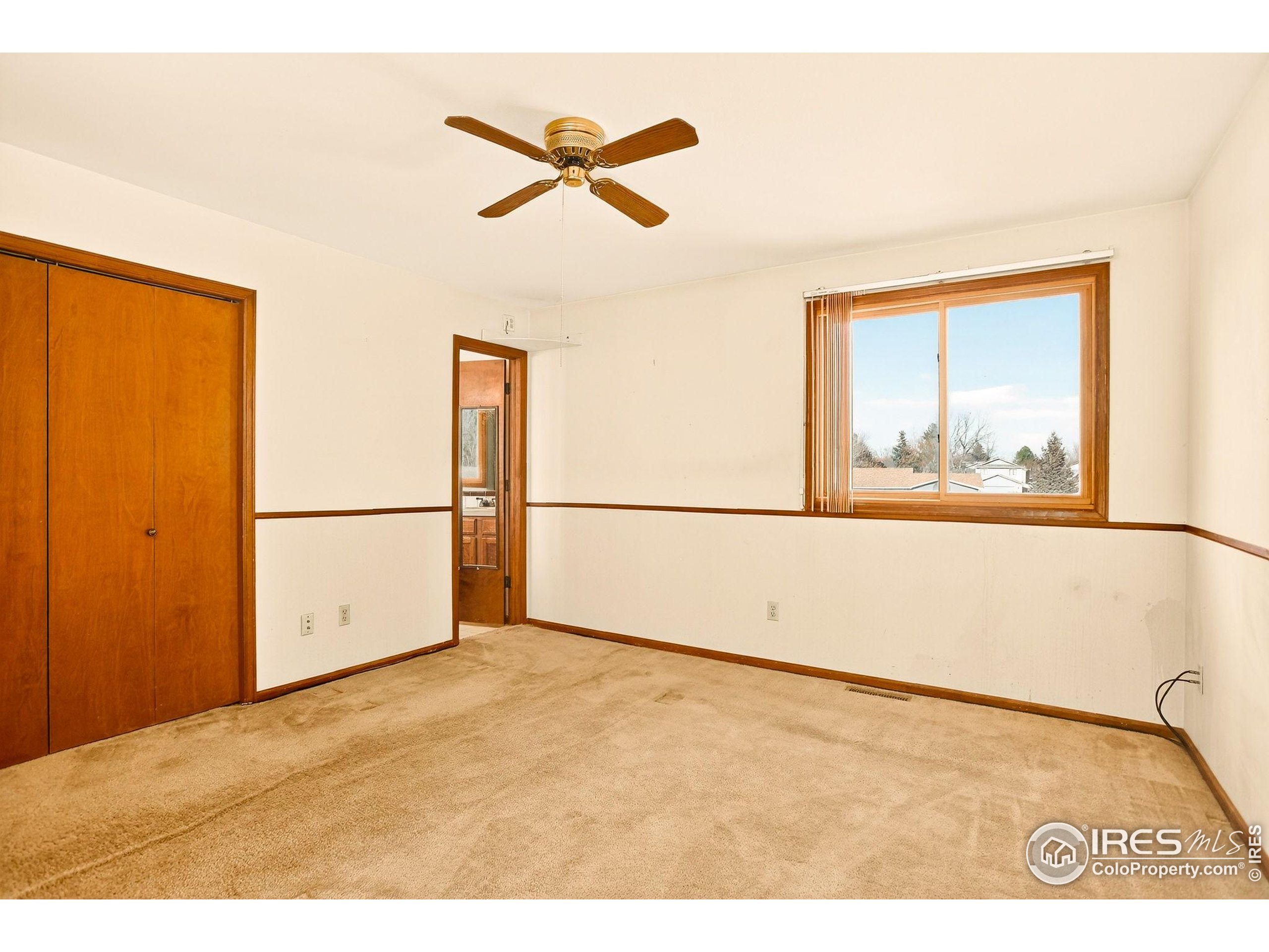 809 Jay Place Berthoud, CO 80513 - Photo 21 of 31 a view of a big room with wooden floor and windows