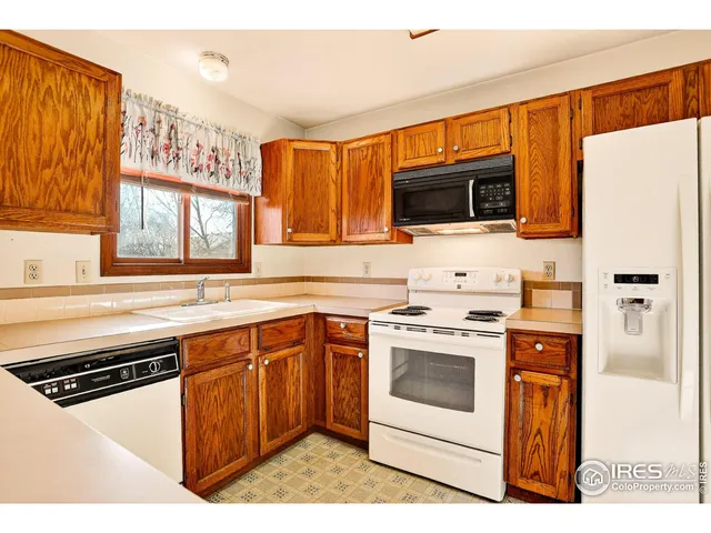 a kitchen with a stove sink and microwave