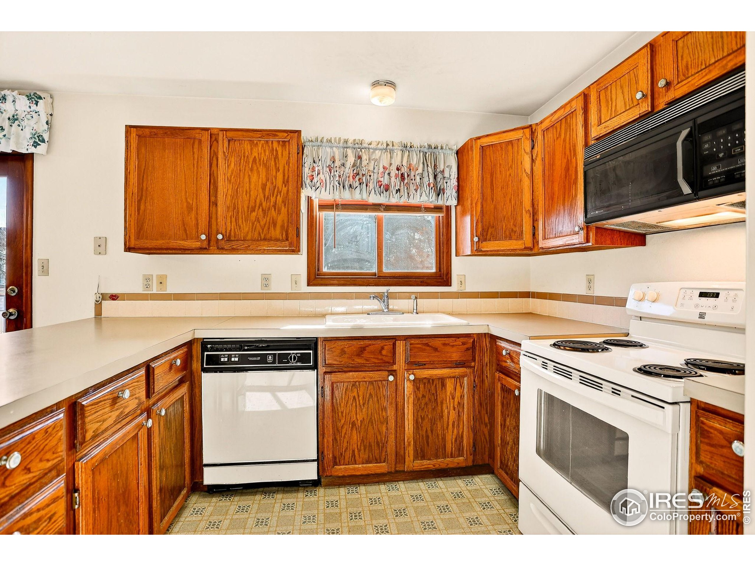 809 Jay Place Berthoud, CO 80513 - Photo 5 of 31 a kitchen with stainless steel appliances granite countertop a stove a sink and a microwave