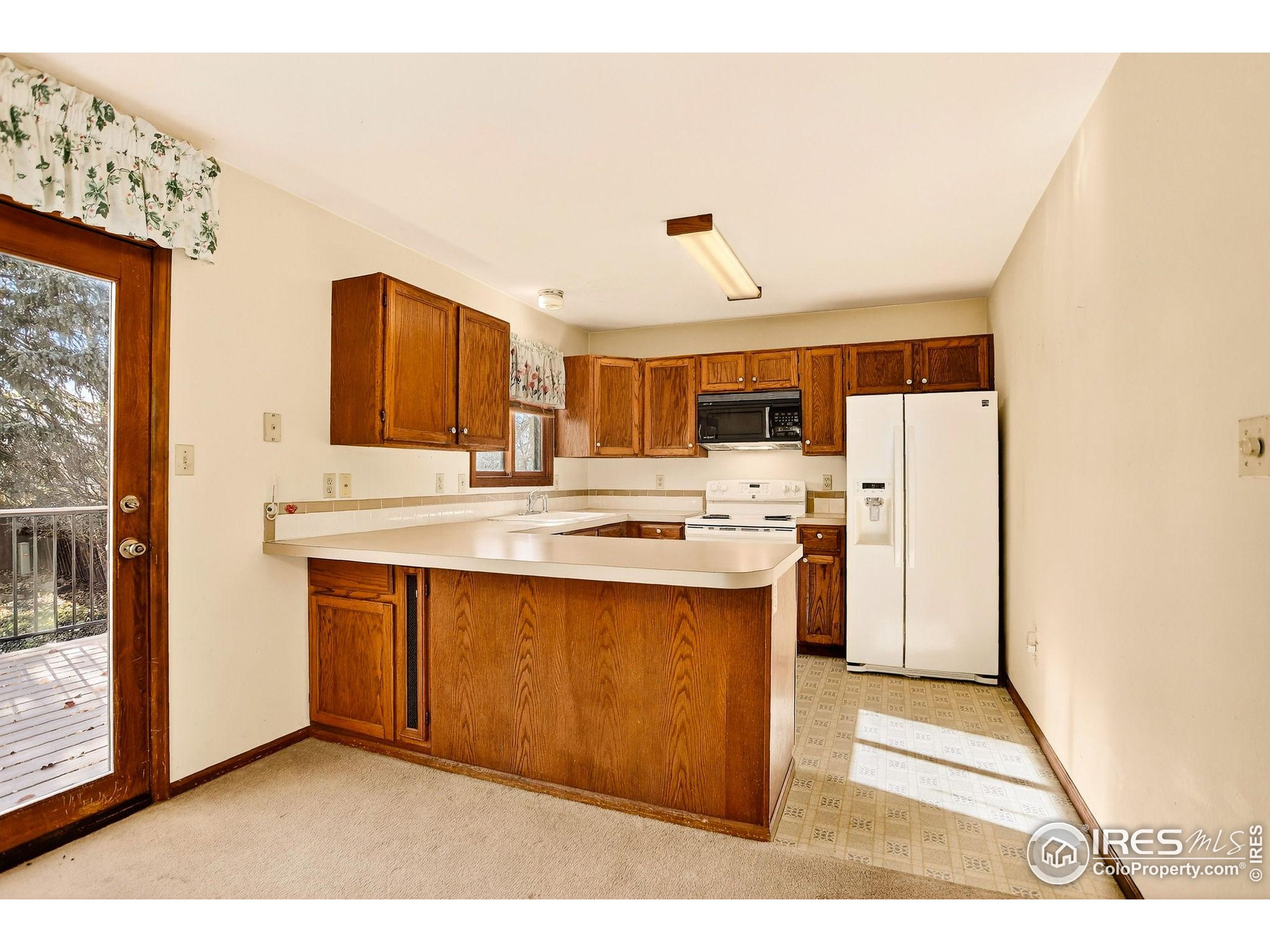 809 Jay Place Berthoud, CO 80513 - Photo 6 of 31 a kitchen with stainless steel appliances a sink stove and refrigerator