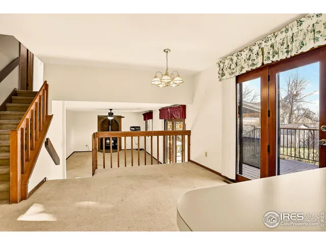 a bedroom with furniture and large window