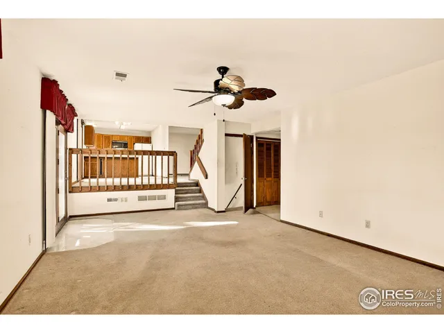 a view of a livingroom with a ceiling fan and window
