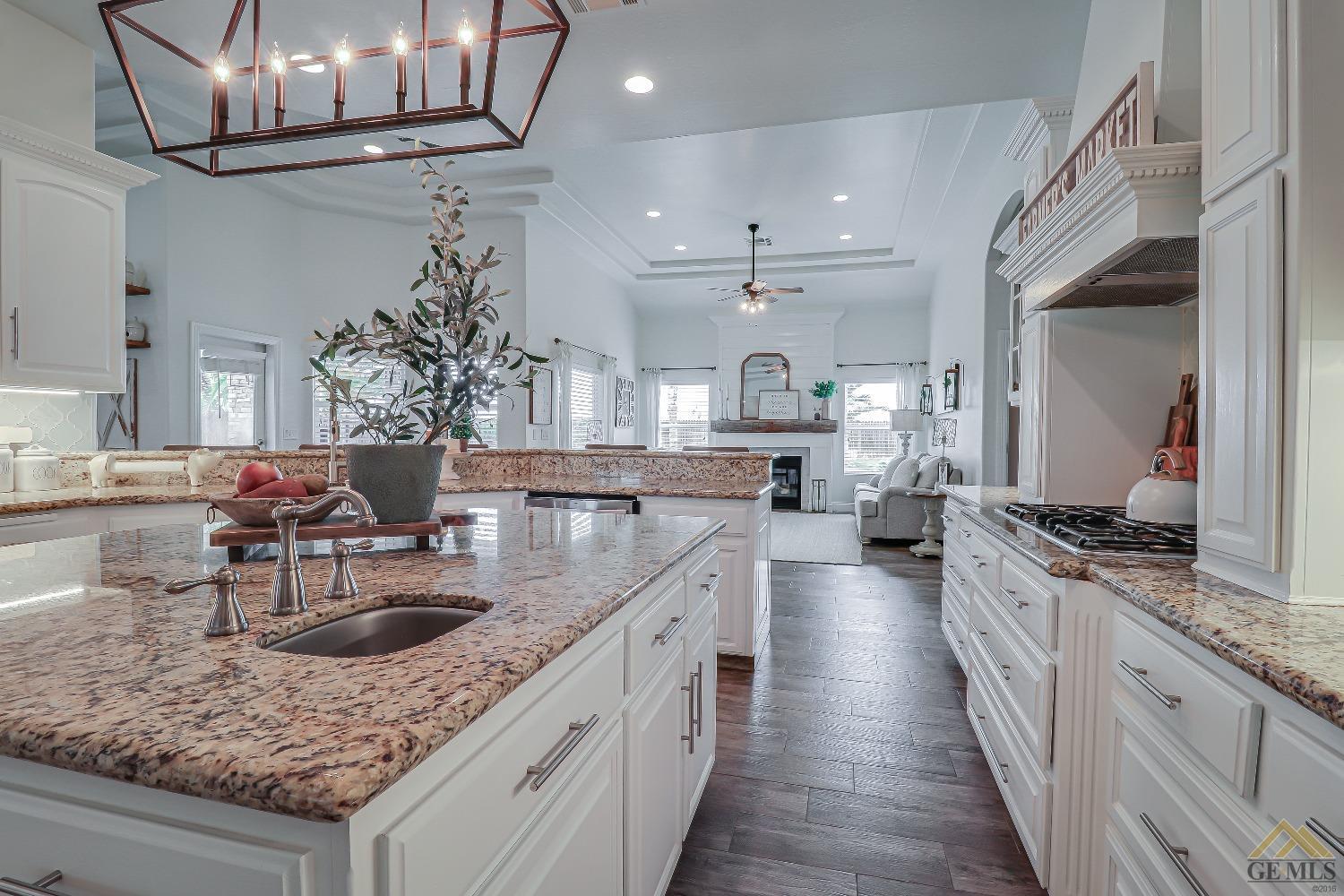 Undisclosed Address Bakersfield, CA 93314 - Photo 11 of 30 a kitchen with stainless steel appliances granite countertop a sink stove and cabinets