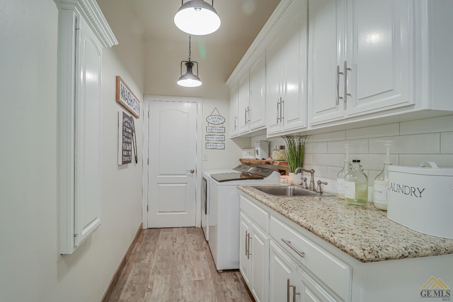 Undisclosed Address Bakersfield, CA 93314 - Photo 13 of 30 a kitchen with a sink and cabinets