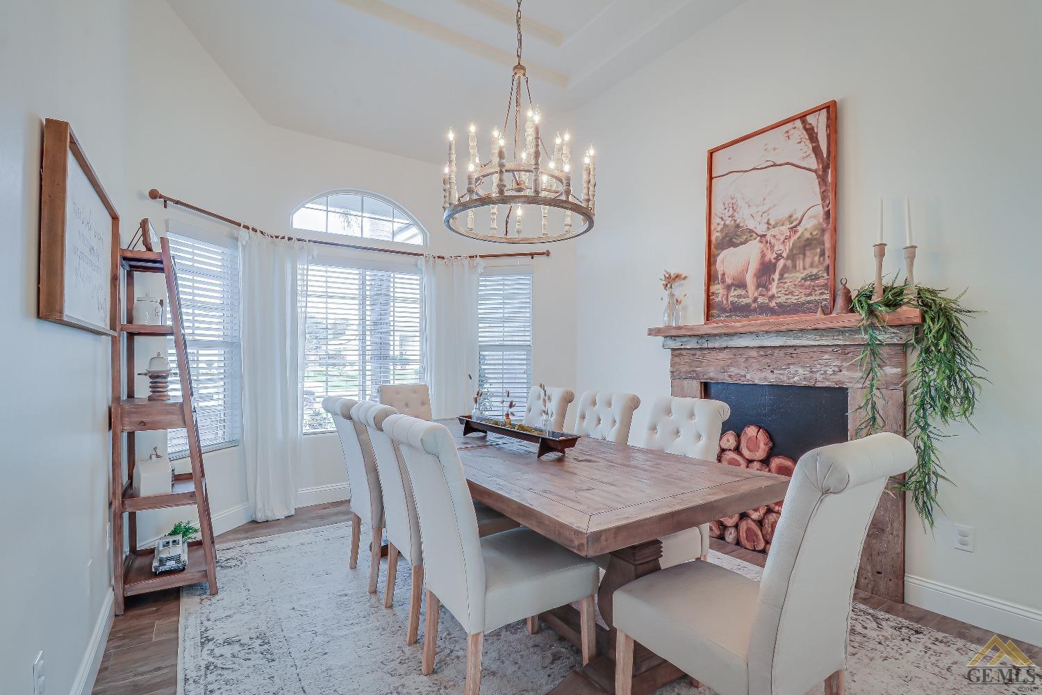 Undisclosed Address Bakersfield, CA 93314 - Photo 15 of 30 a dining room with furniture a fireplace and a chandelier