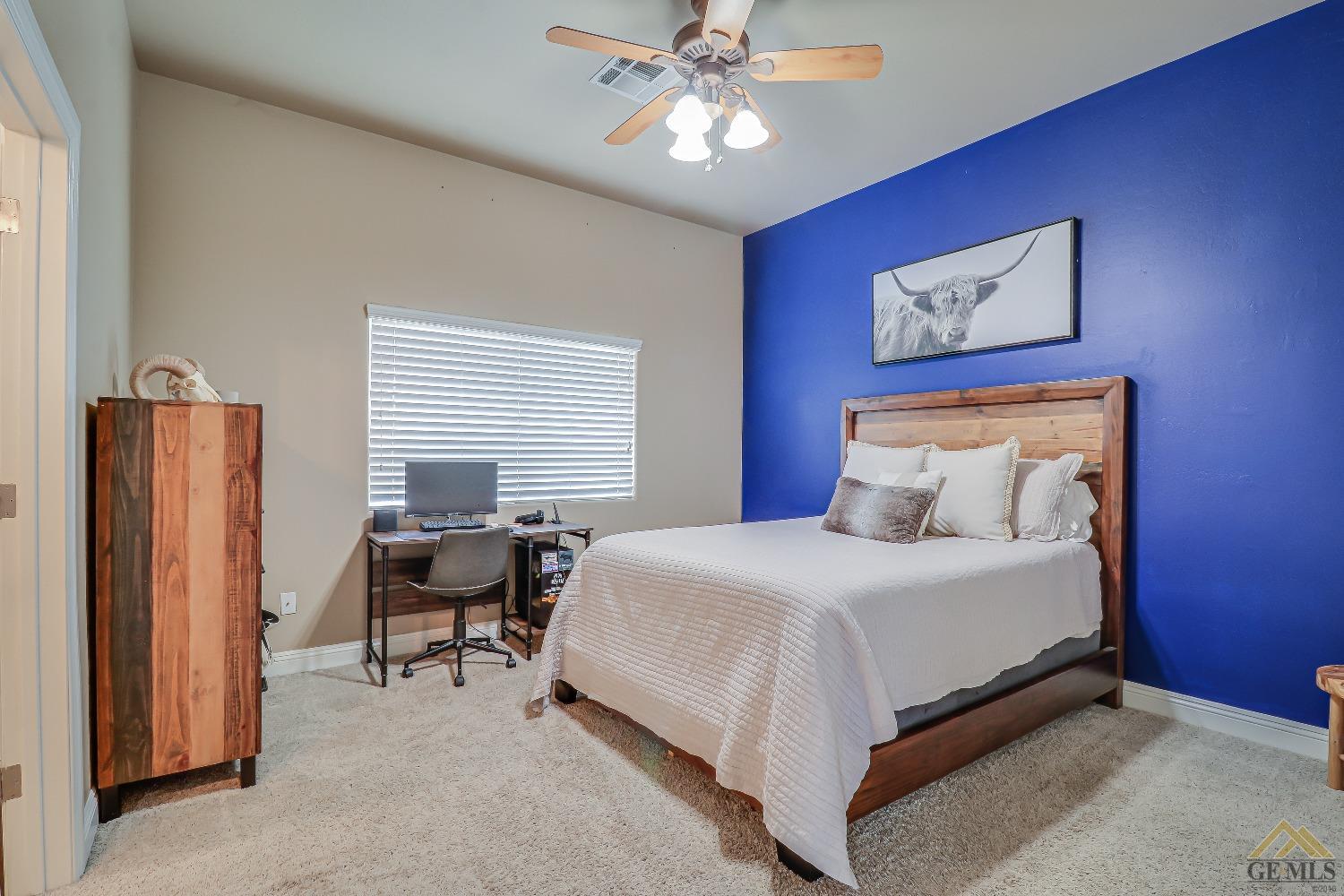 Undisclosed Address Bakersfield, CA 93314 - Photo 16 of 30 a bedroom with a bed and a chandelier