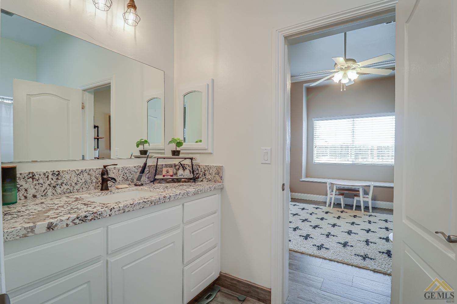 Undisclosed Address Bakersfield, CA 93314 - Photo 17 of 30 a bathroom with a sink and a mirror