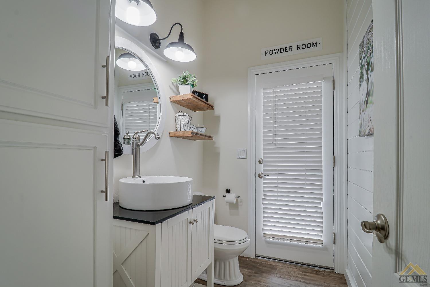 Undisclosed Address Bakersfield, CA 93314 - Photo 19 of 30 a bathroom with a toilet a sink and mirror
