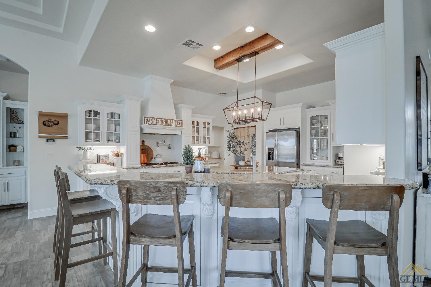 Undisclosed Address Bakersfield, CA 93314 - Photo 8 of 30 a view of a dining room with furniture a chandelier and wooden floor