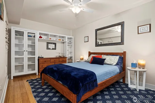 a bedroom with bed and wooden floor