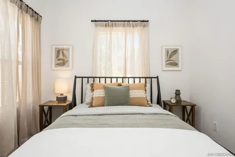 a bedroom with a large bed and a window