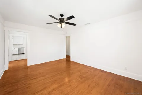 a view of a big room with wooden floor closet and windows