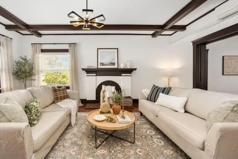 a living room with furniture a rug and a chandelier