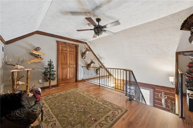 a bedroom with bed and wooden floor