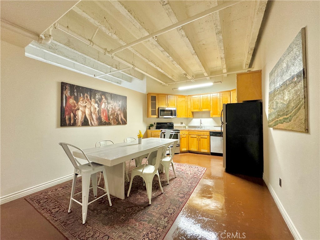 a view of a dining room with furniture a chandelier and wooden floor