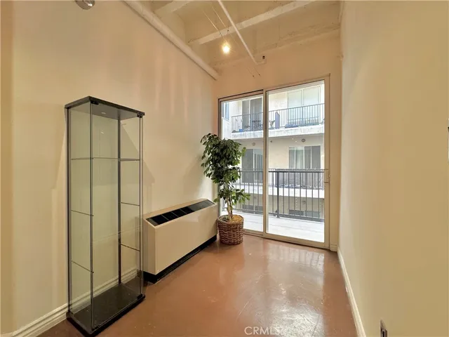 a view of workspace with window and wooden floor