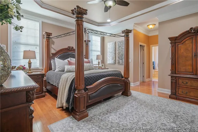 a bedroom with a bed lamp and a large window