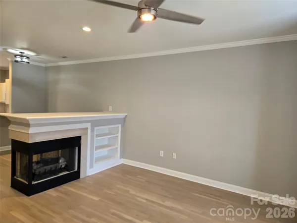 a room with a fireplace and a ceiling fan