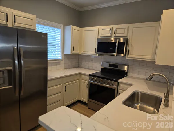 a kitchen with a refrigerator sink and microwave