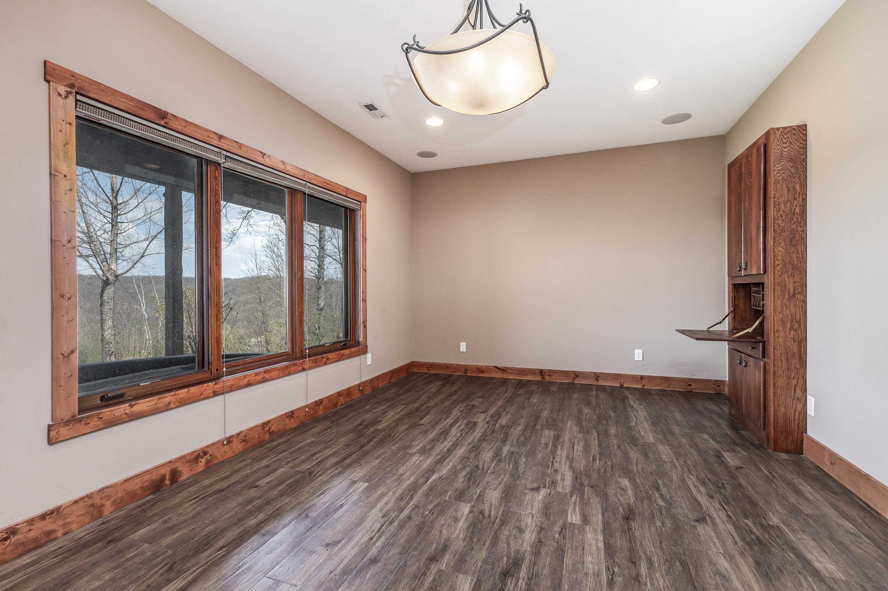 8616 Fisher Road Hanover, IL 61041 - Photo 53 of 74 a view of an empty room with wooden floor and a window