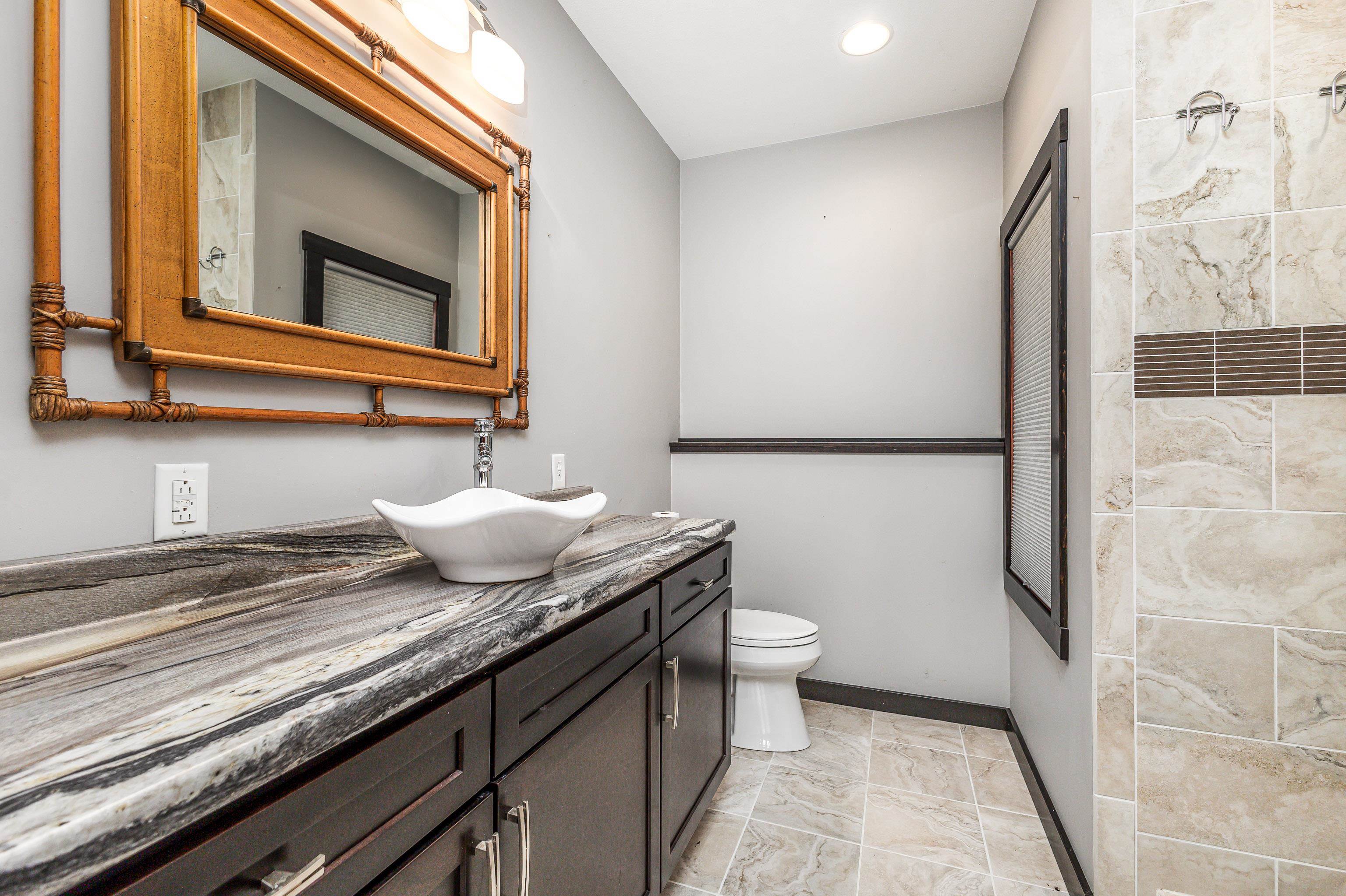 8616 Fisher Road Hanover, IL 61041 - Photo 58 of 74 a bathroom with a granite countertop sink and a mirror