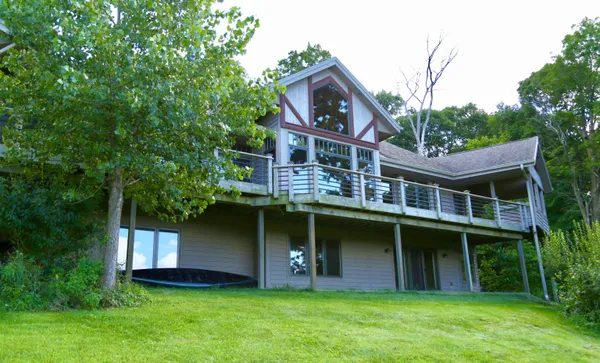 a view of a house with yard and sitting area