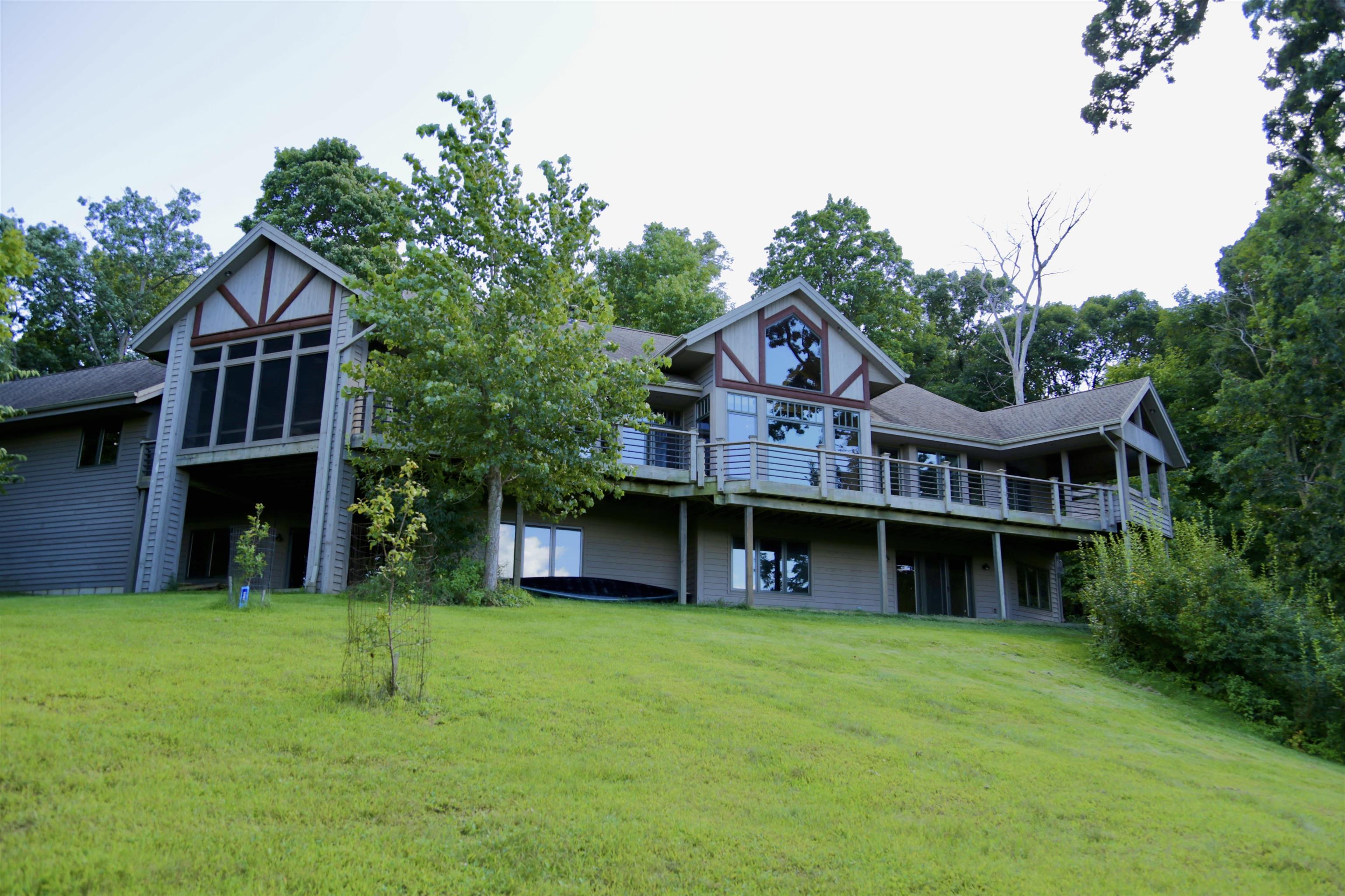 8616 Fisher Road Hanover, IL 61041 - Photo 8 of 74 a view of a big house with a big yard and large trees