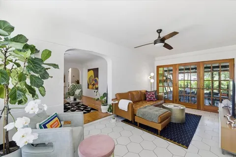 a living room with furniture and a potted plant