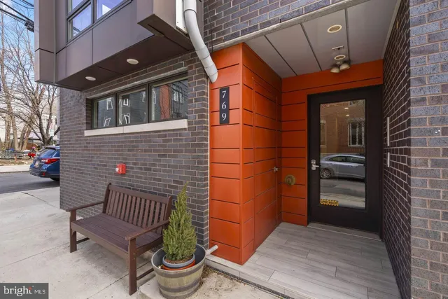 a front view of a house with outdoor seating