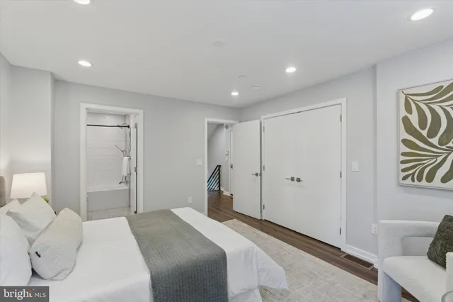 a spacious bedroom with a bed and a couch