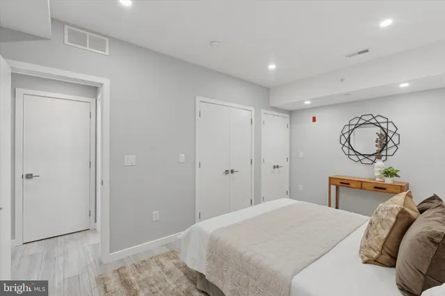 a bedroom with bed and wooden floor